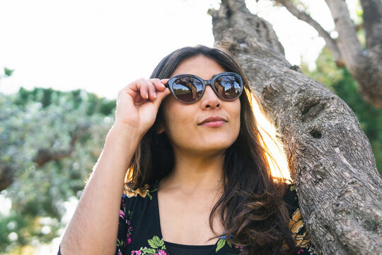 Woman in modern sunglasses in park