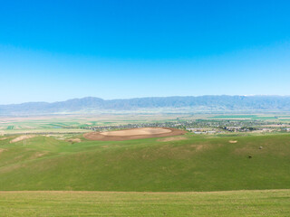 Fototapeta na wymiar Green slopes and blue skies. Kyrgyzstan. tourism and travel