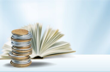 A stack of coins with a Holy Bible Book in the background. The biblical concept of Christian offering, generosity, and giving tithes in church.