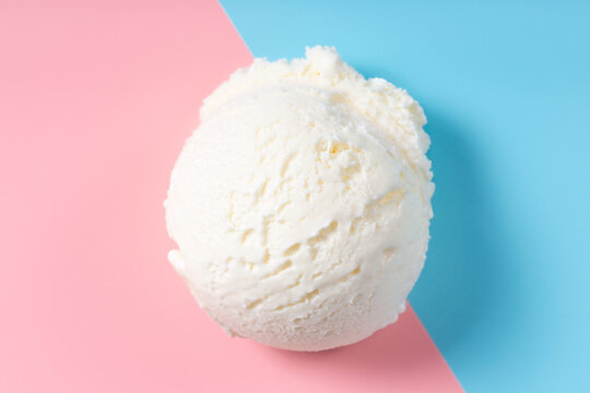 vanilla scoop of sundae ice cream on blue and pink background, top view