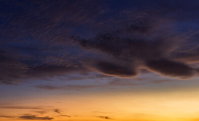 Sunset sky with orange sunrise on dark blue sky background in the morning.