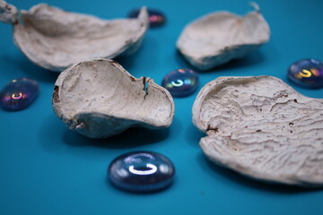 White pot pourri with glass marbles on a blue background