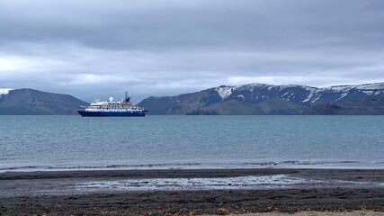 Expedition cruise ship in the bay at Telephone Bay, Deception Island, Antarctica