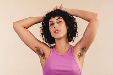 Confident young woman embracing her underarm hair