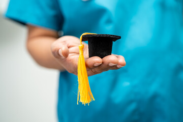 Asian doctor study learn with graduation gap hat in hospital ward, clever bright genius education...