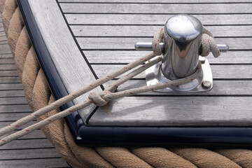 Cast iron split bollard mooring cleat bit with ropes around it to secure a boat to a bollard, indispensable when mooring as it ensures that the boat does not come loose