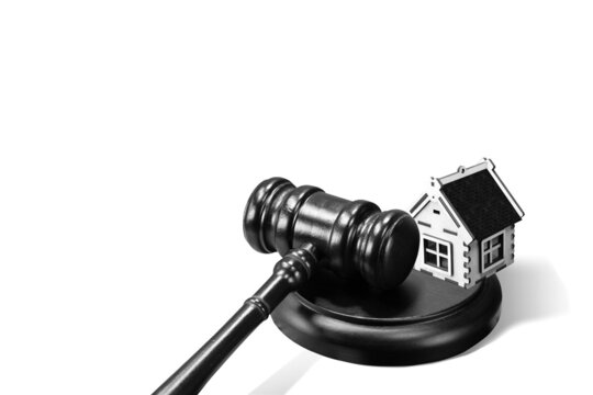 Abstract photo with wooden gavel and abstract house isolated on white background as symbol of sale of mortgage or emergency housing at auction or as symbol of legal dispute over division of real estat