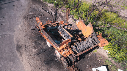 The war in Ukraine, a completely destroyed tank, the remains of a tank standing by the road, a view from a drone, aerial photography