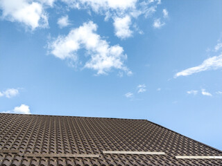 the tiled roof of a house and a clear sky