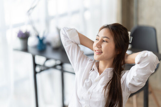 Portrait of beautiful asian woman relaxing in office, Happy relaxed woman having break and resting in office.