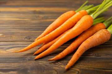 Fresh and sweet carrots on a brown wooden table.Healthy vegan food.Fresh organic carrots.Vegetables. Healthy food.Space for copy.