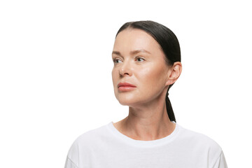 Half-length portrait of serious middle age beautiful woman with well-kept skin on white background. Cosmetics, spa, age-related changes, face lifting and skin care concept