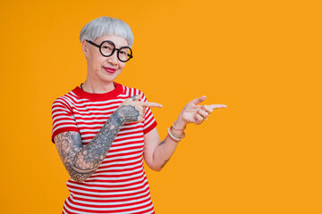 senior asian female grey hair fashioned cloth with tattoo arm standing hand gesture with positive confident expression,old asia woman wear red tshirt carefree lifestyle happiness pension age