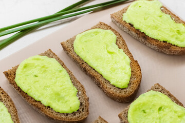 Avocado cream and slices of rye bread. Cooking vegetarian sandwiches. view from above