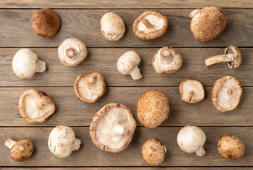 Shimeji, portobello and paris mushrooms over wooden table