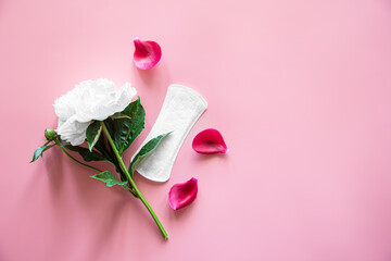 Women's pad and flower, flat lay, women's health and menstruation concept.