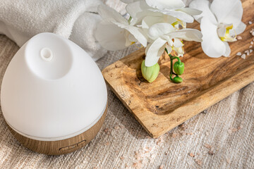 Modern oil aroma diffuser close up on a blurred background.