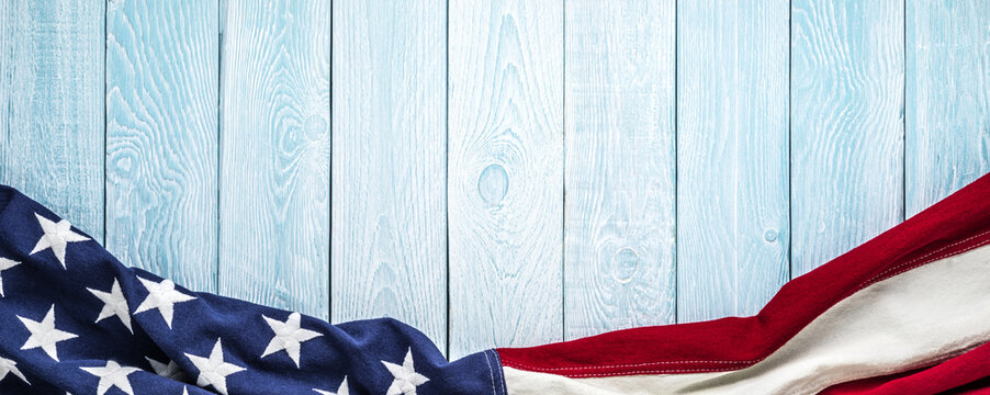 US flag on blue with white wooden planks texture background