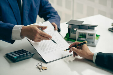 A home agent or sales manager offers a sale and explains the terms of signing a home purchase...