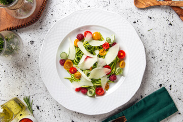 Plate of gourmet fresh vegetable salad on served table