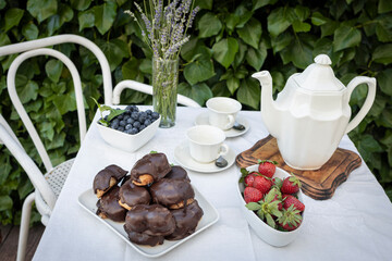 Delicious snack in the garden with fruit and puff pastries with chocolate. Sweets for tea or coffee time in the garden. Typical sweet from Morata de Tajuña (Spain)