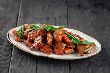 Side view on korean fried yangnyeom chicken with spring onion