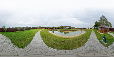 Full seamless 360 degree HDRI spherical panorama in park with lake and patio, guest tent and guest...