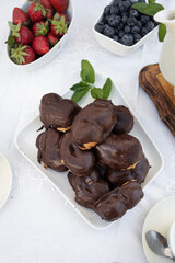 Delicious snack in the garden with fruit and puff pastries with chocolate. Sweets for tea or coffee time in the garden. Typical sweet from Morata de Tajuña (Spain)