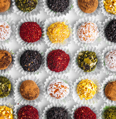 Closeup on box of assorted craft chocolate candies with different toppings