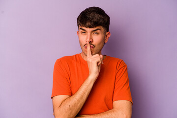 Young caucasian man isolated on purple background keeping a secret or asking for silence.