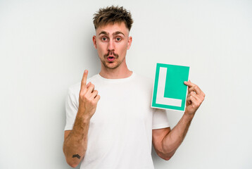 Young caucasian man holding L placard isolated on white background having some great idea, concept of creativity.