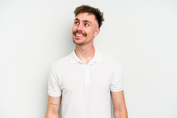 Fototapeta premium Young caucasian man isolated on white background relaxed and happy laughing, neck stretched showing teeth.