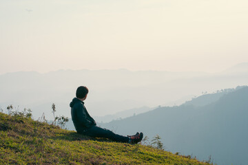 hiker man relax with wellbeing and happy feeling on top of mountain