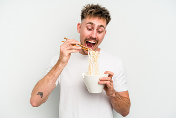 Young caucasian man eating noodles isolated on white background