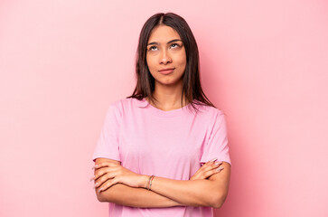 Fototapeta premium Young hispanic woman isolated on pink background tired of a repetitive task.