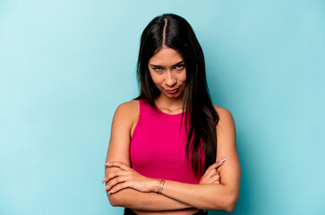 Obraz premium Young hispanic woman isolated on blue background unhappy looking in camera with sarcastic expression.