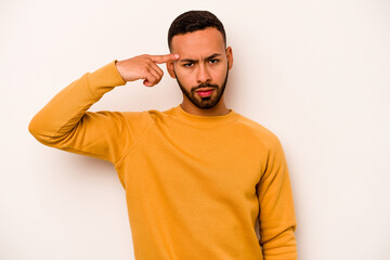 Young hispanic man isolated on white background pointing temple with finger, thinking, focused on a task.