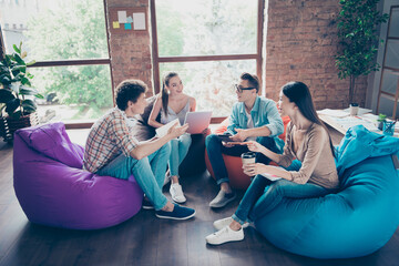 Photo of cheerful funny workers group sitting dorm discussing new study program indoors workplace...