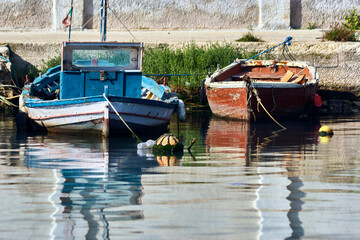Fototapeta na wymiar Two ancient fishing boats moored