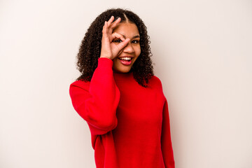 Young African American woman isolated on white background excited keeping ok gesture on eye.