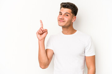 Young caucasian man isolated on white background showing number one with finger.