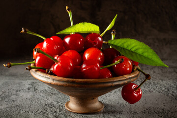 Cherries in earthenware and green leaves