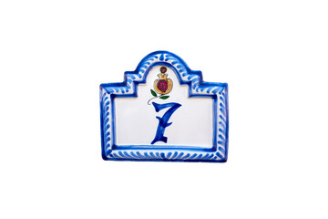 Close-up of Spanish Villa House Address Plaque with Pomegranate. House number 7. Porcelain plaque with a Pomegranate drawing. Isolated image. 