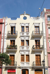 Naklejka premium Facade of a beautiful apartment with wooden windows and balconies.