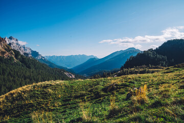 Scenery nature landscape of mountains surrounded by green meadows. Peaceful atmosphere and ideal environment for relaxation. Beautiful background
