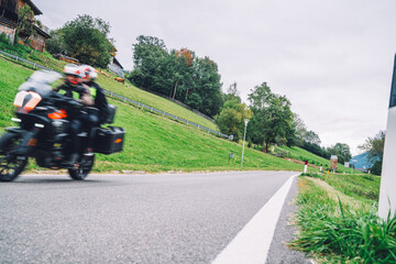 Fototapeta na wymiar Motorcycle rides a serpentine in a beautiful mountainous area, motion blur effect. Motorcycle trip in Europe