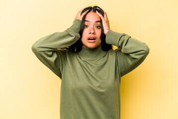 Young hispanic woman isolated on yellow background surprised and shocked.