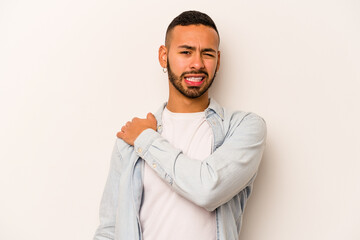 Young hispanic man isolated on white background having a shoulder pain.
