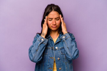 Young hispanic woman isolated on purple background having a head ache, touching front of the face.