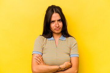 Fototapeta premium Young hispanic woman isolated on yellow background unhappy looking in camera with sarcastic expression.